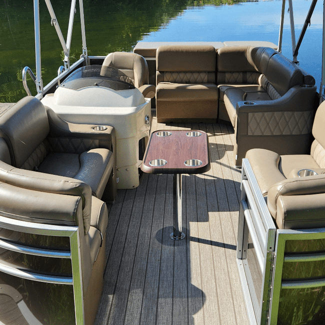 Pontoon boat with luxury beige furniture bench, corner, cupholder, and helm chair