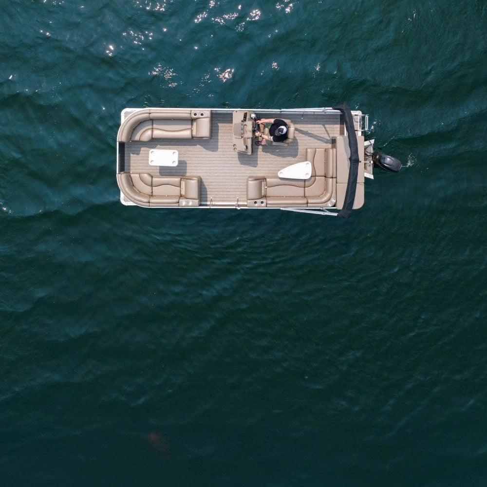 Top Down View of a pontoon boat on the water with bench seats, corner seats, lean backs, rectangle table, triangle table, and a stern entry fencing