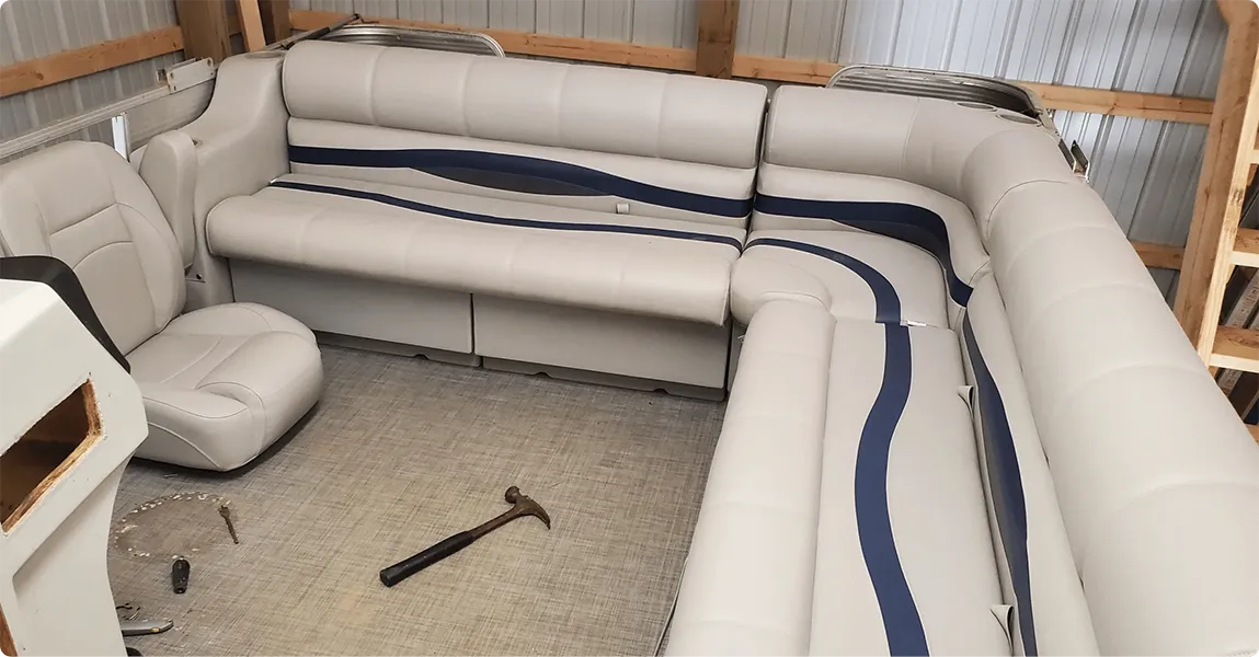 Premium pontoon furniture bench seats and corner seats being worked on and helm chair