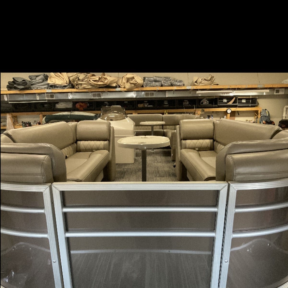 Pontoon boat with luxury beige furniture lean back seats, bench seats, corner seats, 2 tables, and a console