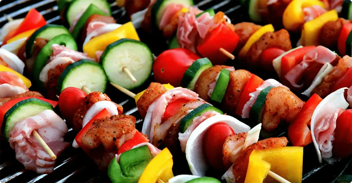Colorful skewers with vegetables and meat on a grill