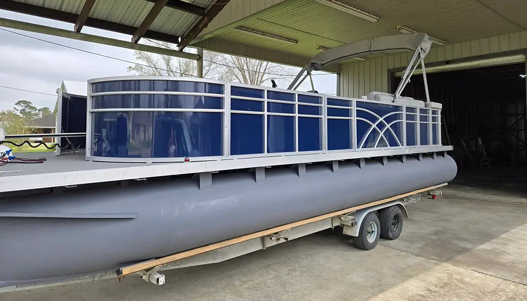 Pontoon boat on a trailer with Navy fencing
