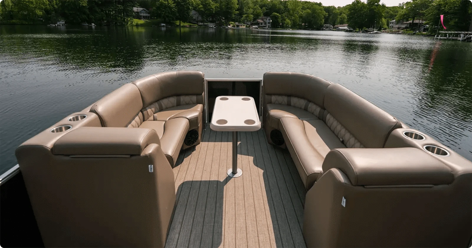 Pontoon boat with luxury pontoon furniture lean backs, corner seats, and bench seats and a table