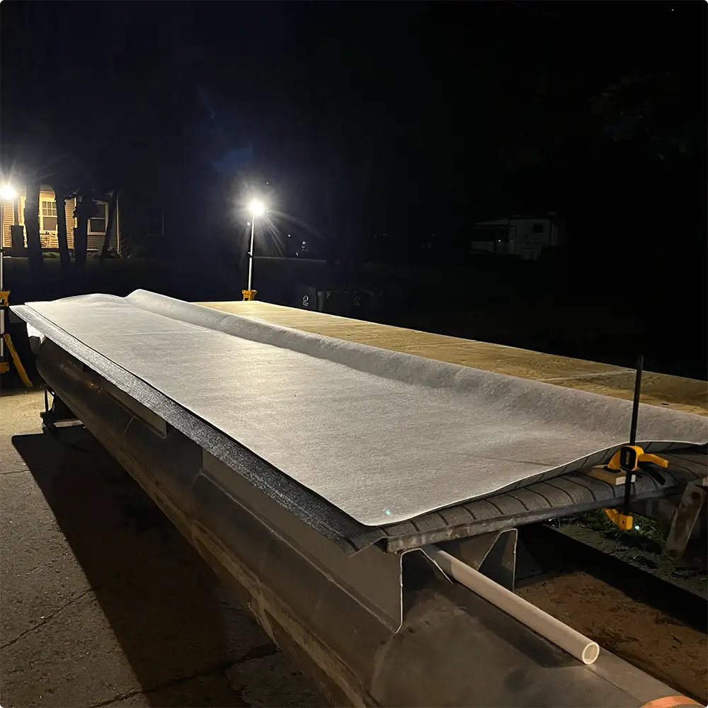 Pontoon boat deck vinyl being applied