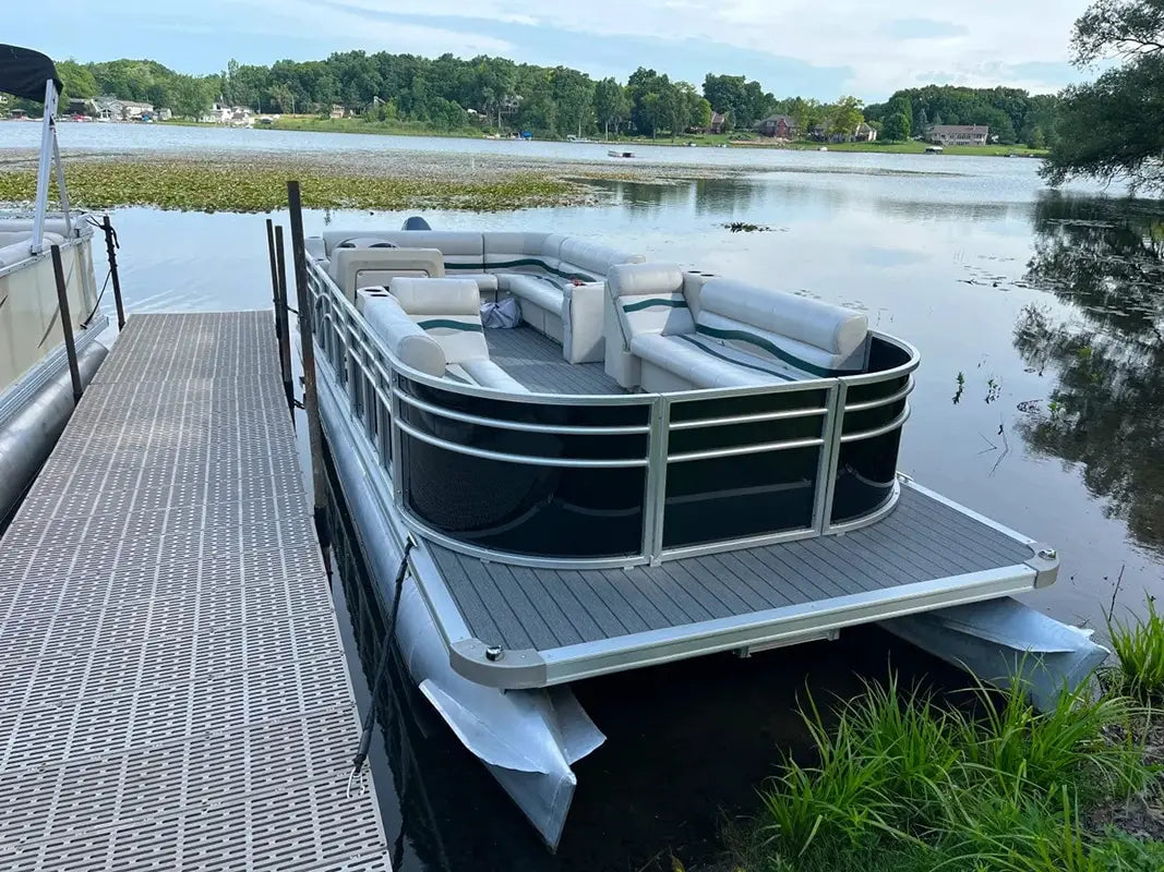 Pontoon boat with premium furniture and a black fencing