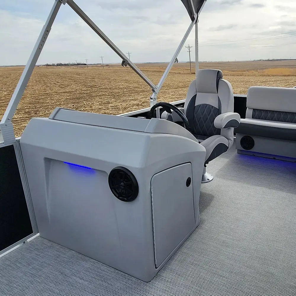 Luxury furniture on a pontoon boat with a console, helm chair, and bench seat