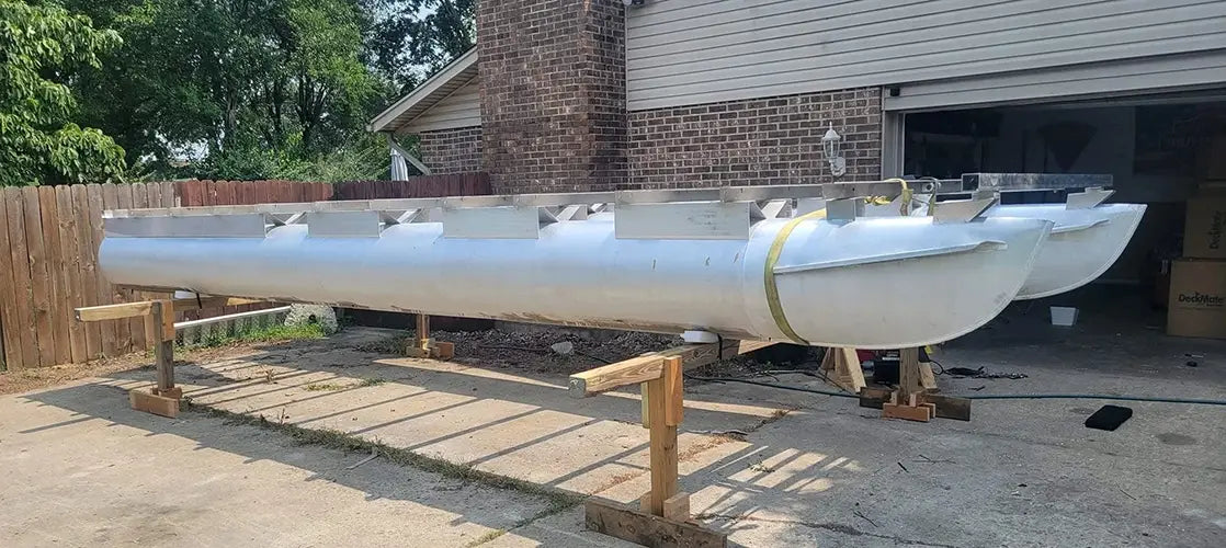 Pontoons on stand being worked on